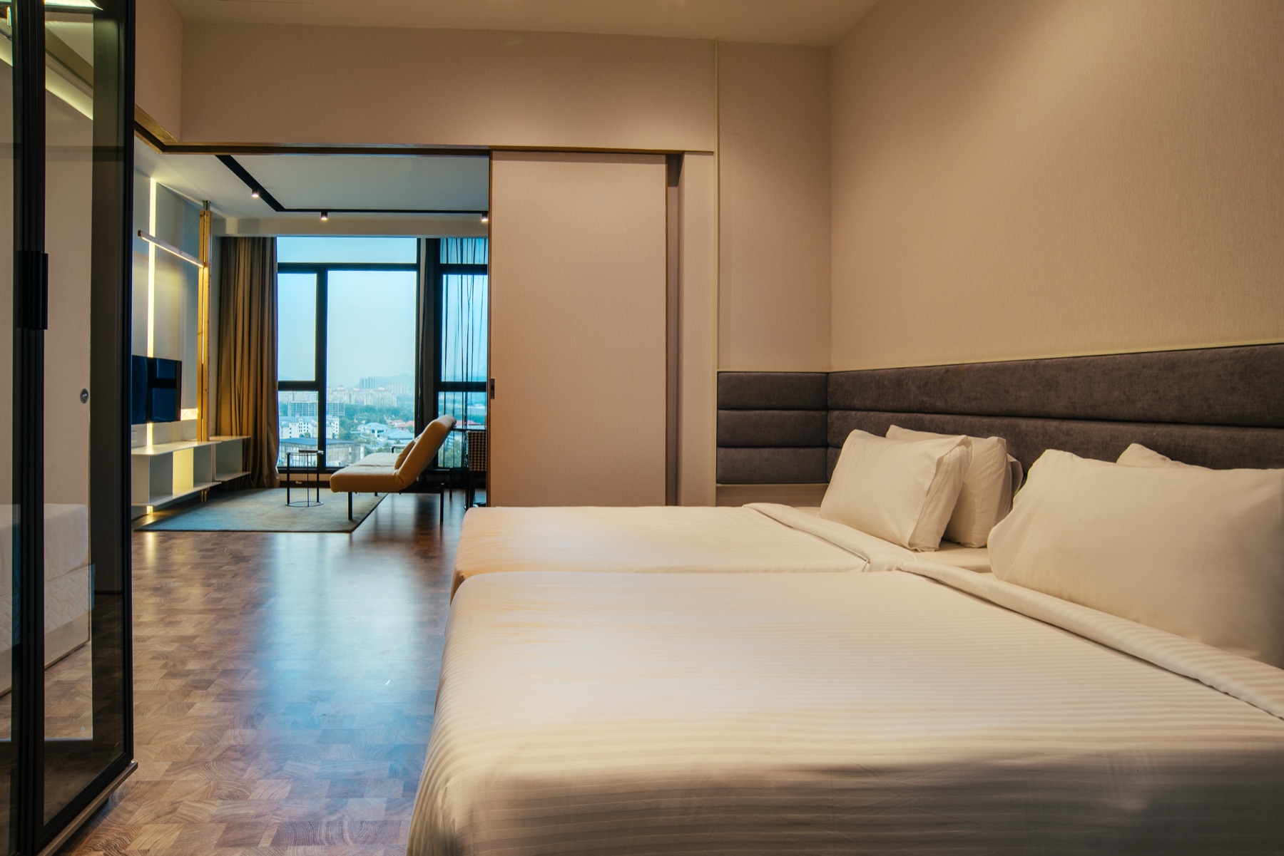 Expressionz Professional Suites living room with open kitchen and city views